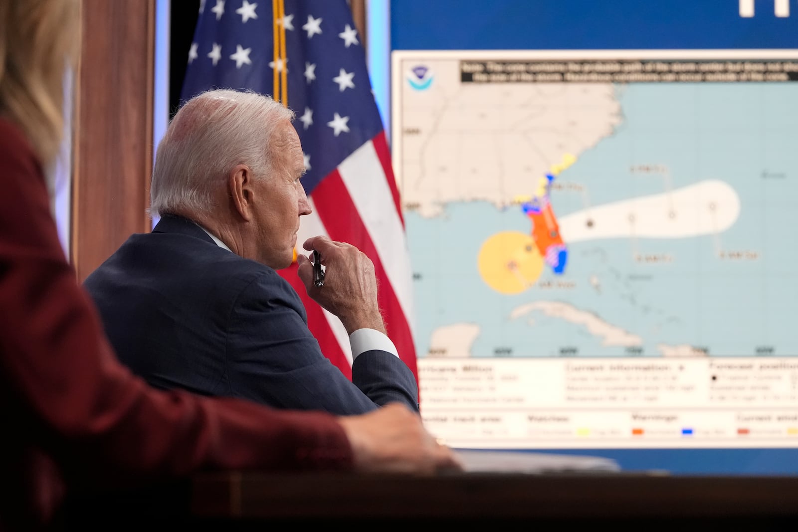 President Joe Biden, joined virtually by Vice President Kamala Harris and by Elizabeth Sherwood-Randall, Homeland Security Advisor to the President, left, listens to a briefing about preparations for Hurricane Milton and the response to Hurricane Helene in the South Court Auditorium on the White House complex in Washington, Wednesday, Oct. 9, 2024. (AP Photo/Mark Schiefelbein)