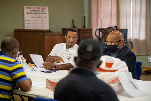 Pastor Hosea Miller Jr., left, of New True Fellowship Baptist Church, speaks during a clergy meeting hosted by Pastor Michael White at Litman Cathedral House of God Saints In Christ in Albany, earlier this month. The pastors and clergy men have been meeting to discuss how to combat the gun violence in their neighborhoods. (Alyssa Pointer/Atlanta Journal Constitution)