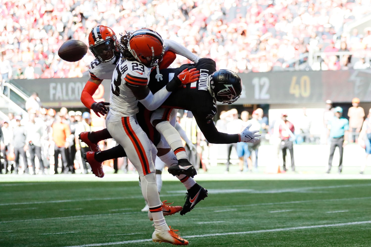 Falcons wide receiver Drake London is unable to catch the ball under pressure from Browns defenders during the first quarter Sunday in Atlanta. (Miguel Martinez / miguel.martinezjimenez@ajc.com)