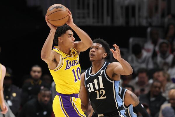 Atlanta Hawks forward De'Andre Hunter (12) guards Los Angeles Lakers guard Max Christie (10) during the first half against the Los Angeles Lakers at State Farm Arena, Tuesday, January 30, 2024, in Atlanta. (Jason Getz / jason.getz@ajc.com)