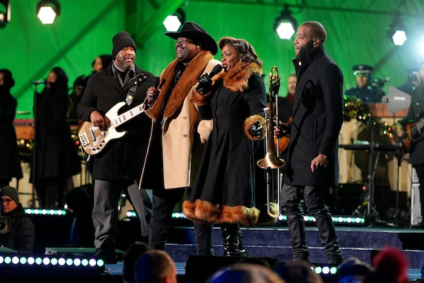 Michael Trotter Jr. (center left) and Tanya Blount (center right) of The War and Treaty, Adam Blackstone (left) and Trombone Shorty perform during a ceremony lighting the National Christmas Tree on the Ellipse near the White House in Washington on Dec. 5. Jacquelyn Martin/AP