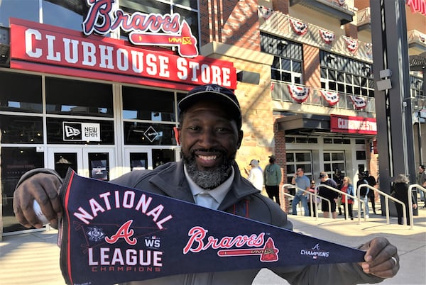 Lavar Height picked up some Braves gear for his son, Harrison, from the Braves Clubhouse Store on Monday before the team's first appearance in the 2021 World Series. There was a long line of buyers waiting to get in the store by noon, excited about the team's National League Championship and their appearance in the World Series 2021. (Photo credit: Christopher Quinn / christopher.quinn@ajc.com)