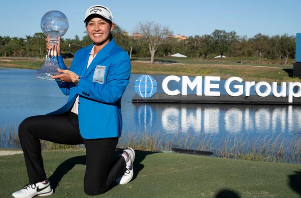 Jeeno Thitikul poses on the 18th green with the LPGA CME Group Tour Championship golf tournament trophy sunday, Nov. 24, 2024, in Naples, Fla. (AP Photo/Chris Tilley)