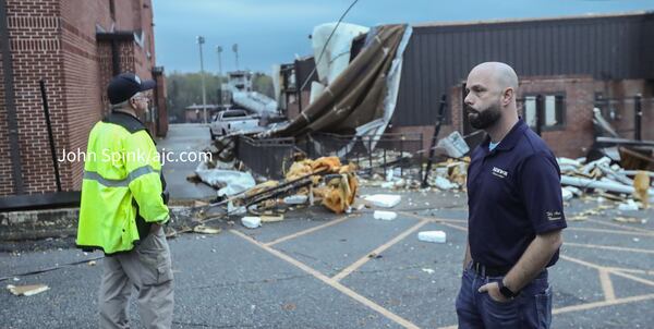 Officials survey storm damage at Newnan High School on Friday.