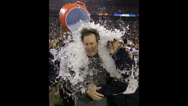 FILE PHOTO - In this Feb. 6, 2005, file photo, New England Patriots head coach Bill Belichick is doused after the Patriots beat the Philadelphia Eagles 24-21 in Super Bowl XXXIX at Alltel Stadium in Jacksonville, Fla. At right is Belichick's father, Steve. 