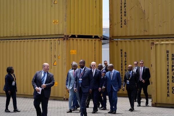 President Joe Biden, center, and Angola's President Joao Lourenco, right, tour the Lobito Port Terminal in Lobito, Angola, on Wednesday, Dec. 4, 2024. (AP Photo/Ben Curtis)