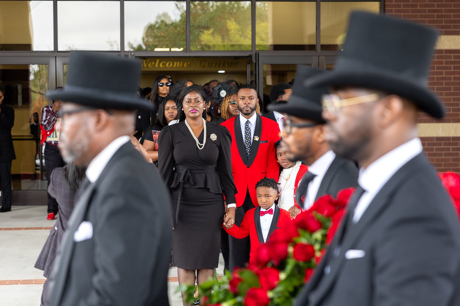 Family of radio host Wanda Smith watch as her casket is brought out following her funeral service at Word of Faith Cathedral in Austell on Monday, November 4, 2024. (Arvin Temkar / AJC)