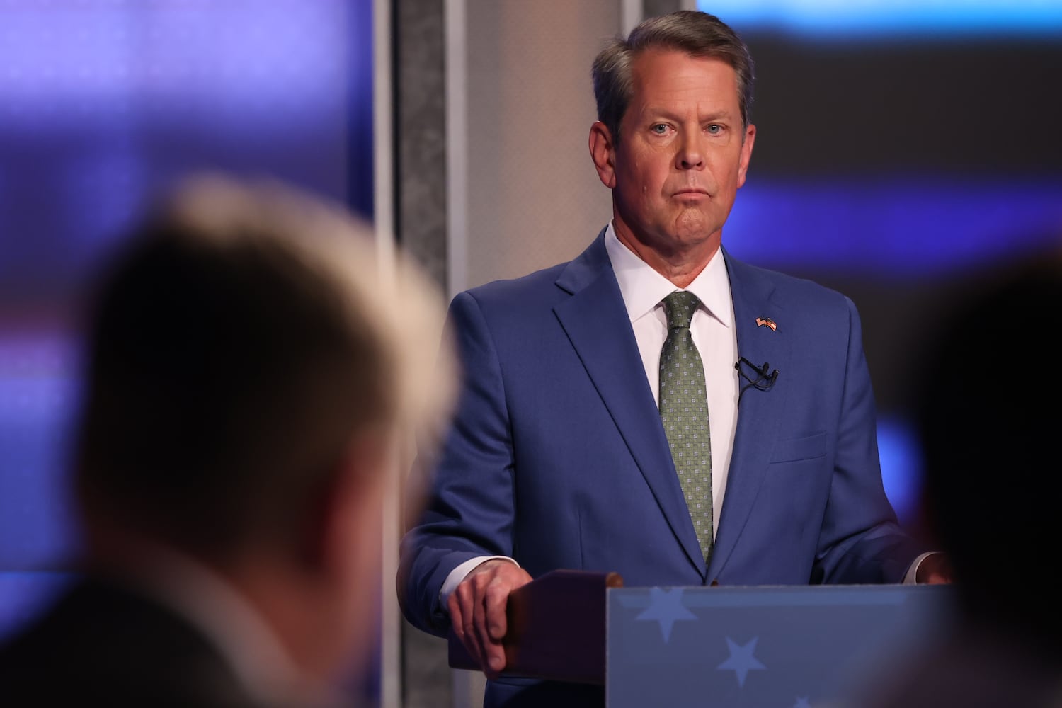 Gov. Brian Kemp observes AJC political reporter Greg Bluestein as he asks him a question during the first debate of the Republican primary for governor. As expected, the debate was very intense between the two candidates on Sunday, April 24, 2022, at WSB-TV. (Photo: Miguel Martinez/miguel.martinezjimenez@ajc.com)