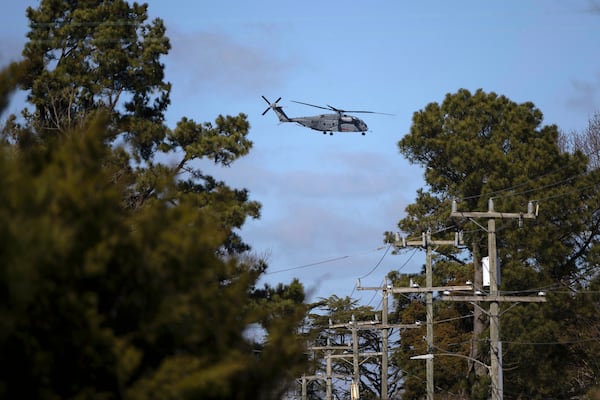 FILE - A U.S. Navy CH-53 Super Stallion helicopter flies near Naval Air Station Oceana, Feb. 8, 2024, in Virginia Beach, Virginia. (AP Photo/Tom Brenner, File)