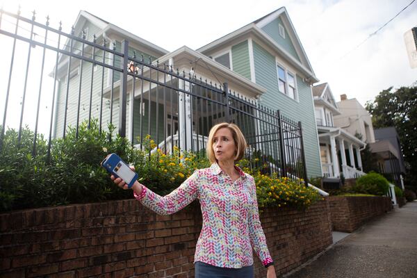 Jennifer Bentson, an Old Fourth Ward resident, stands in front of her house and discusses the impacts of a proposed Atlanta Streetcar extension. Bentson said she supports transit on the Beltline but opposes the proposed streetcar extension. CHRISTINA MATACOTTA FOR THE ATLANTA JOURNAL-CONSTITUTION.