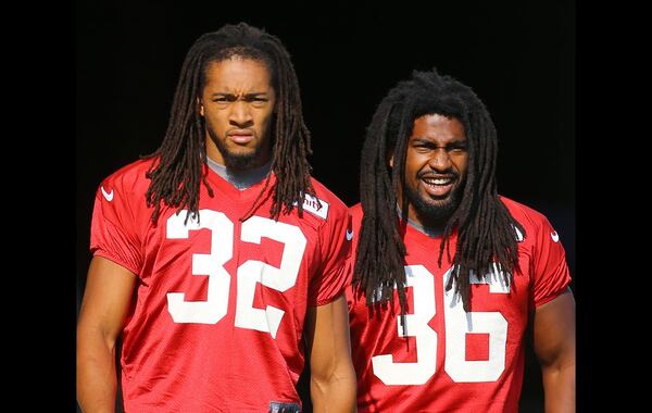 073115 FLOWERY BRANCH: Falcons cornerback Jalen Collins (left) and safety Kemal Ishmael take the field for the first day of training camp on Friday, July 31, 2015, in Flowery Branch. Curtis Compton / ccompton@ajc.com