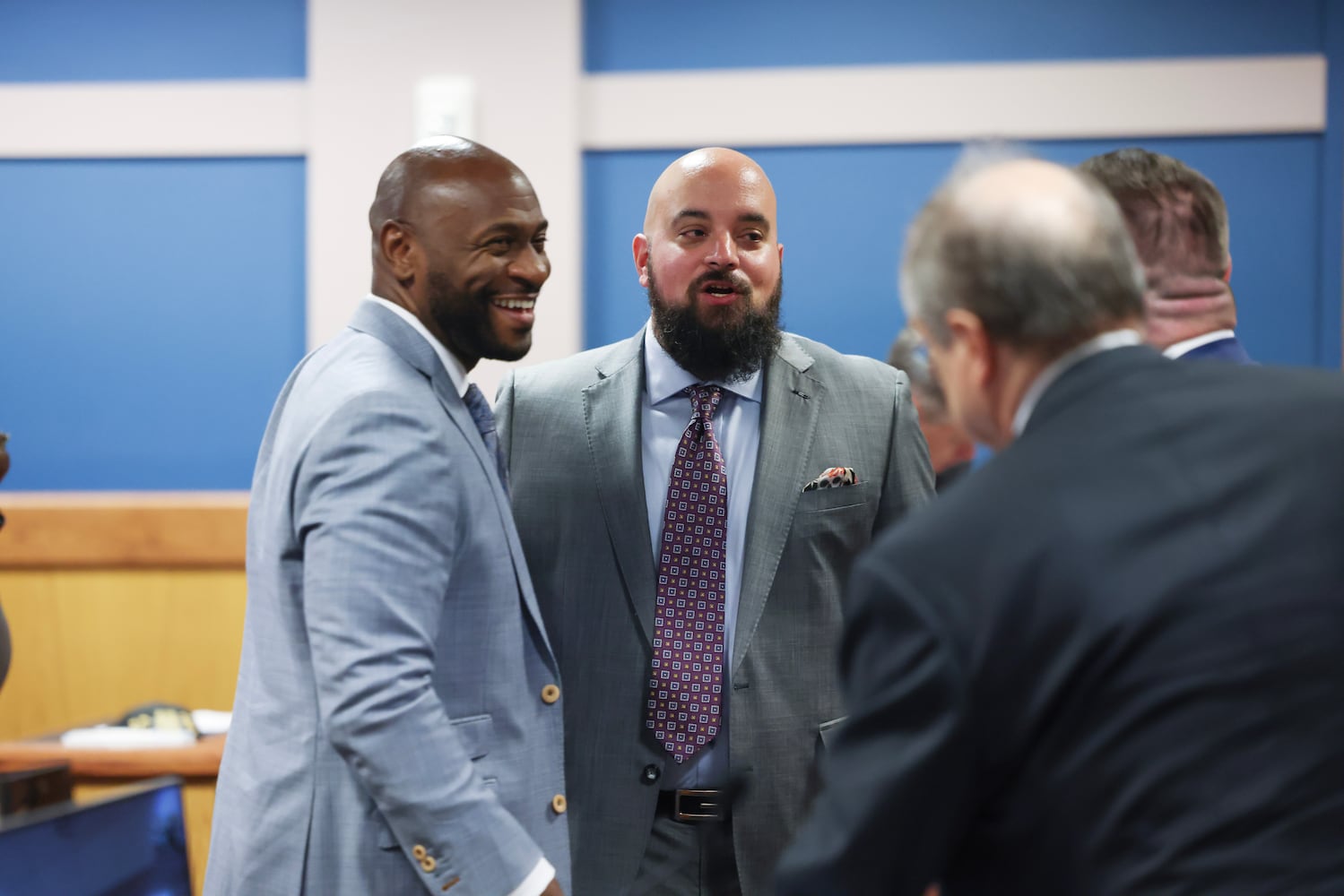 Special Prosecutor Nathan Wade (left), representing the District Attorney's office, talks with Attorney Scott Grubman, who is defending Ken Chesebro, and other attorneys after Fulton County Superior Judge Scott McAfee heard motions from attorneys representing Ken Chesebro and Sidney Powell in Atlanta on Wednesday, Sept. 6, 2023.   (Jason Getz / Jason.Getz@ajc.com)