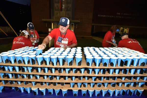 Volunteer Sam Shock (center) setting up water station near Shepherd Center.