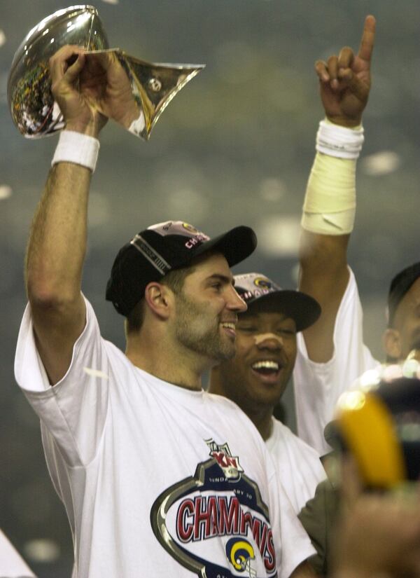 000130 - ATLANTA, GA.: St. Louis Rams record-setting quarterback Kurt Warner celebrates following a close win over the Tennessee Titans Sunday, 1/30/00 at the Georgia Dome in Super Bowl XXXIV. Rams won 23-16 after Tennessee made a last-ditch, near goal-line effort. (PHOTO BY BEN GRAY/STAFF)