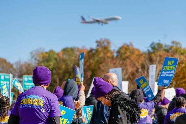 An airplane arrives at Charlotte Douglas International Airport as airport workers strike in front of the Charlotte Douglas International Airport in Charlotte, N.C., Monday, Nov. 25, 2024. (AP Photo/Nell Redmond)