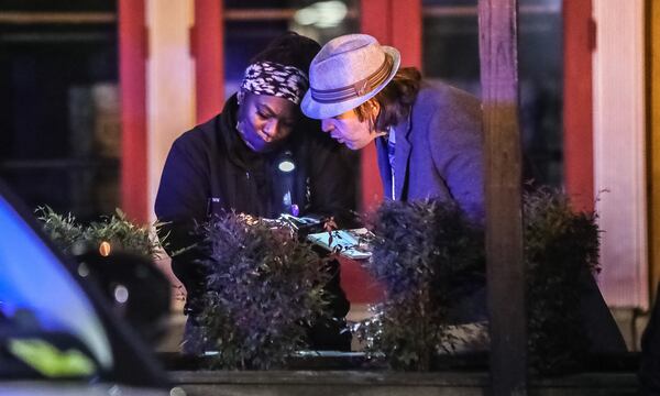 Atlanta police collect evidence at the scene of a deadly shooting at the corner of 12th Street and Crescent Avenue on Friday morning.