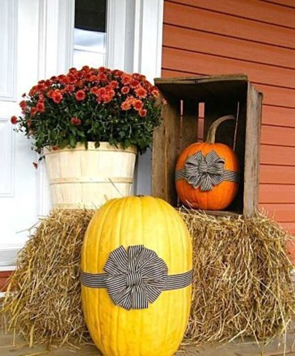 Tie a ribbon around a pumpkin for a simple outdoor display.