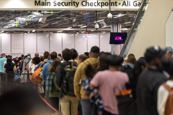 People gather in line at the Hartsfield-Jackson Atlanta International Airport on Monday, March 27, 2023. (Arvin Temkar / arvin.temkar@ajc.com)