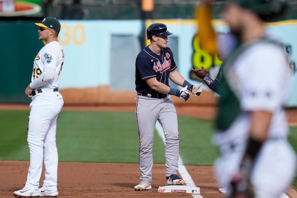 Atlanta Braves' Sean Murphy, center, reacts after hitting an RBI-single against the Oakland Athletics during the first inning of a baseball game in Oakland, Calif., Monday, May 29, 2023. (AP Photo/Godofredo A. Vásquez)