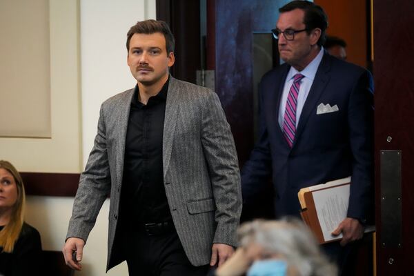 Morgan Wallen, left, enters a courtroom to plea guilty to reckless endangerment charges related to throwing a chair off a six-story balcony Thursday, Dec. 12, 2024, in Nashville, Tenn. (AP Photo/George Walker IV)