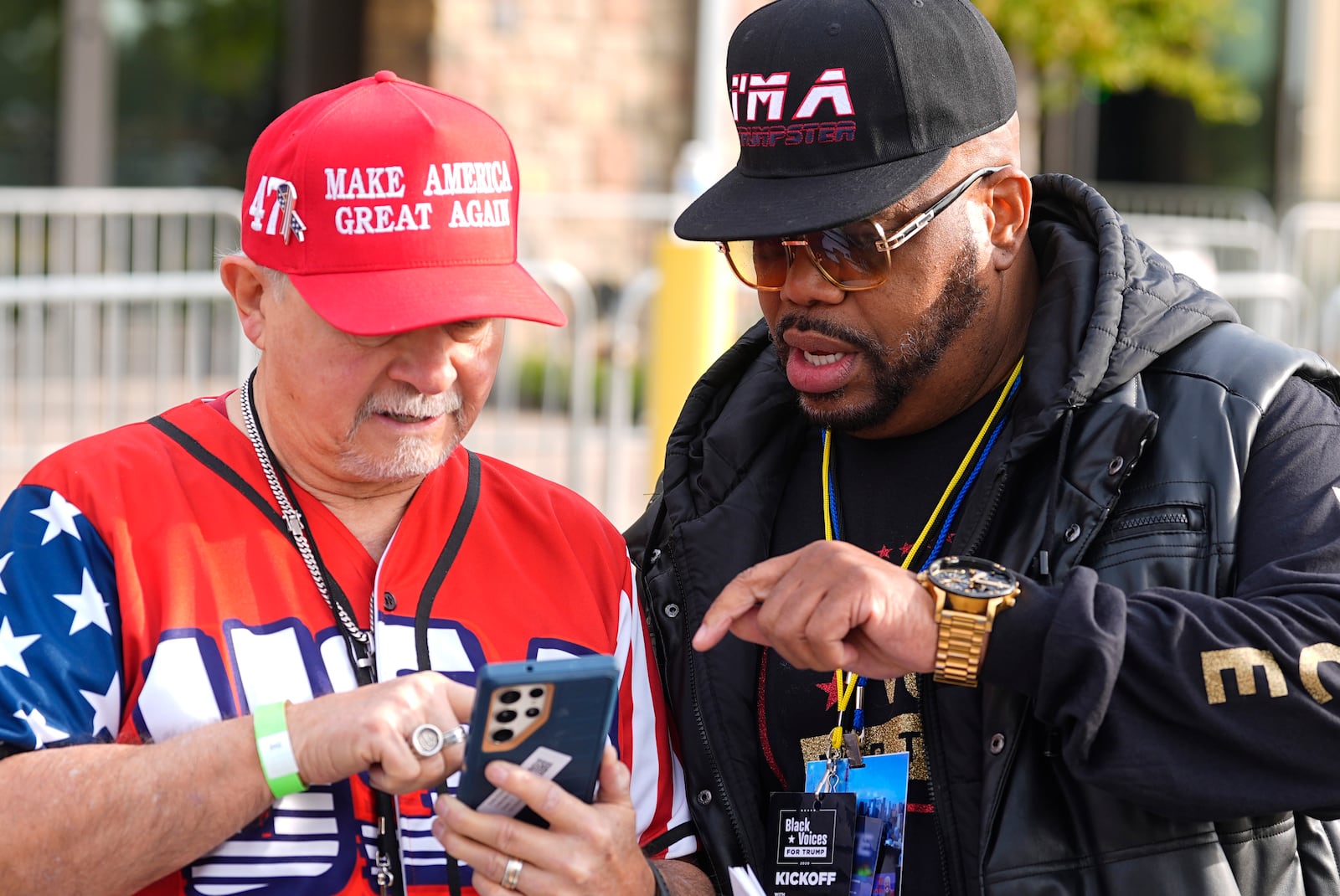 Supporters of Republican presidential nominee former President Donald Trump check their mobile devices before Trump speaks at a campaign rally at the Gaylord Rockies Resort and Convention Center Friday, Oct. 11, 2024, in Aurora, Colo. (AP Photo/David Zalubowski)