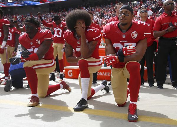 The San Francisco 49ers’ Eli Harold, Colin Kaepernick (center) and Eric Reid kneel during the national anthem before their game against the Dallas Cowboys on Oct. 2, 2016, at Levi’s Stadium in Santa Clara, Calif. (Nhat V. Meyer/Bay Area News Group/TNS)