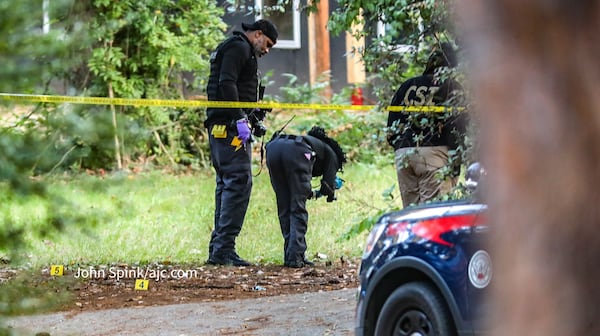 Investigators take pictures of evidence after a fatal shooting Tuesday in southwest Atlanta. 