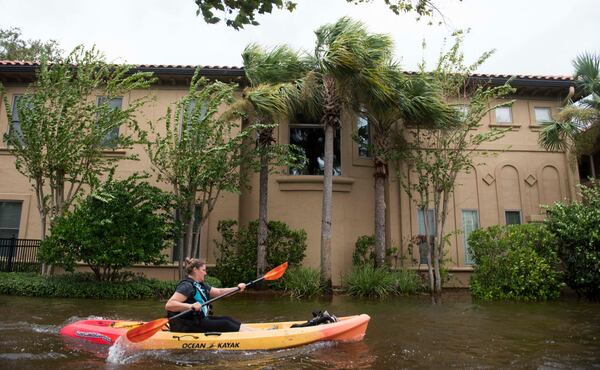 A woman kayaks to her house through the flooded streets of the San Marco’s historic district in Jacksonville, Florida, on September 11, 2017, after storm surge from Hurricane Irma left the area flooded.