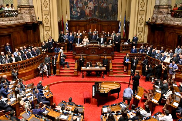 Uruguay's newly sworn-in President Yamandu Orsi, center back at podium, addresses Congress on Inauguration Day, in Montevideo, Uruguay, Saturday, March 1, 2025. (AP Photo/Santiago Mazzarovich)