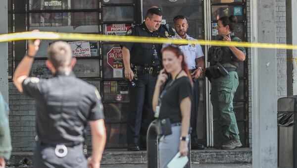 Atlanta police have established a crime scene at the Pure gas station on the corner of Jonesboro and Hutchens roads after two people were found shot Thursday. One has died, according to police.