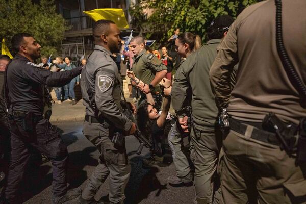 Police disperse people protesting against Prime Minister Benjamin Netanyahu's government and calling for the release of hostages held in the Gaza Strip by the Hamas militant group, near the Prime Minister's residence in Jerusalem, Monday, Oct. 28, 2024. (AP Photo/Ohad Zwigenberg)