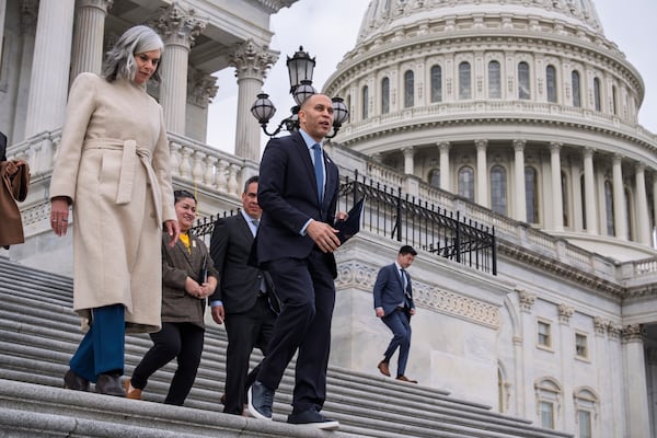 House Minority Leader Hakeem Jeffries, D-N.Y., center, joined at left by Rep. Katherine Clark, D-Mass., arrives to speak against the Republican budget plan, on the House steps at the Capitol in Washington, Tuesday, Feb. 25, 2025. (AP Photo/J. Scott Applewhite)