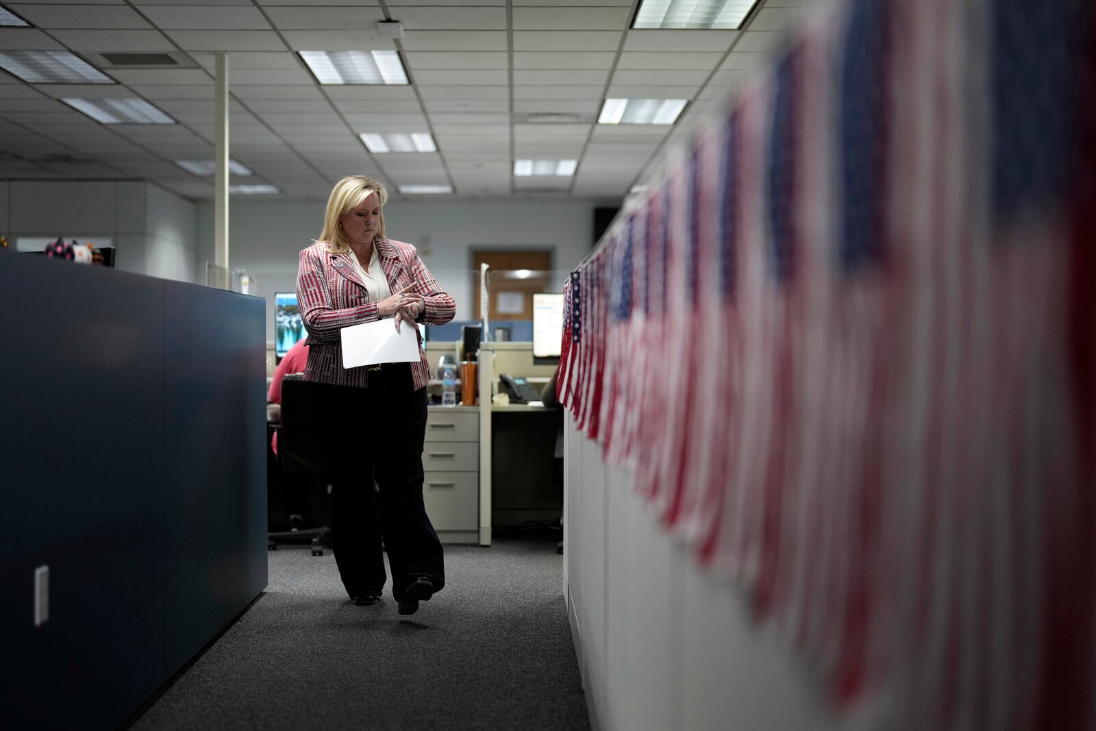 FILE - Cari-Ann Burgess, interim registrar of voters for Washoe County, Nev., walks through the office Sept. 20, 2024, in Reno, Nev. (AP Photo/John Locher, File)