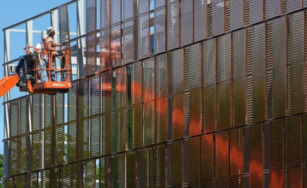 Construction workers install sections of the copper-colored facade on the Marcus Nanotechnology Research Center Building on the Georgia Tech campus. John Spink/AJC 2008