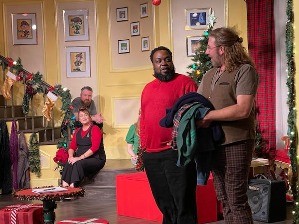 Narrator Topher Payne greets special guest Enoch King during a 2022 improv comedy performance of "Y’allmark Christmas," as improvisers Amber Nash and Kevin Gillese watch from the steps.