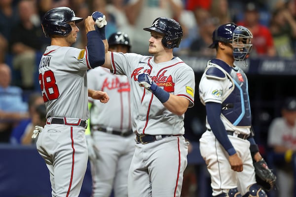 Atlanta Braves' Sean Murphy, center, celebrates his two-run home run with Matt Olson, left, as Tampa Bay Rays catcher Christian Bethancourt stands nearby during the fourth inning of a baseball game Friday, July 7, 2023, in St. Petersburg, Fla. (AP Photo/Mike Carlson)