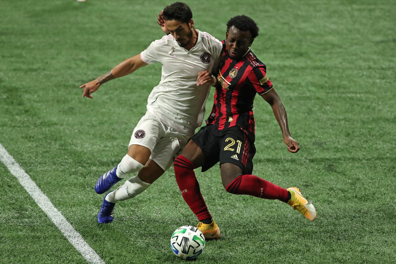 Atlanta United defender George Bello attempts to kick the ball against Miami defender Nicolas Figal (5) in the second half at Mercedes-Benz Stadium Saturday, September 19, 2020 in Atlanta. Atlanta United lost to Miami 2-1. JASON GETZ FOR THE ATLANTA JOURNAL-CONSTITUTION