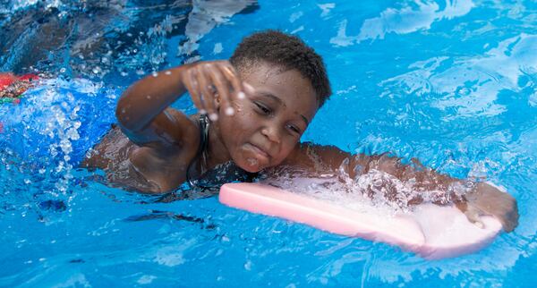 Israel Ferguson practices a swim stroke (age 7, CQ according to organizer). After COVID shuttered pools, a Fayetteville man offered his backyard pool for swimming instruction & water safety lessons to Atlanta city kids. SwemKids is a nonprofit that offers free swimming gear & lessons as an in-school program for kids in low income neighborhoods.  PHIL SKINNER FOR THE ATLANTA JOURNAL-CONSTITUTION.