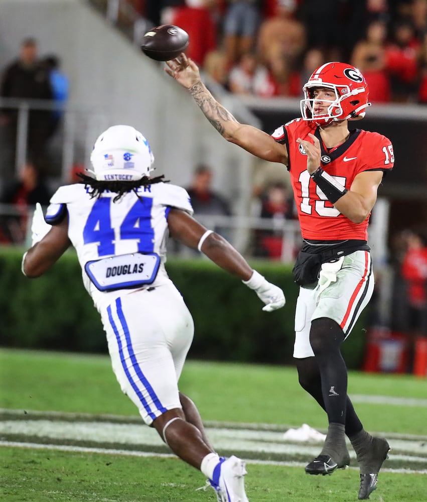 Georgia quarterback Carson Beck completes a pass past Kentucky inside linebacker Martez Thrower during the third quarter in a NCAA college football game on Saturday, Oct. 7, 2023, in Athens.  Curtis Compton for the Atlanta Journal Constitution