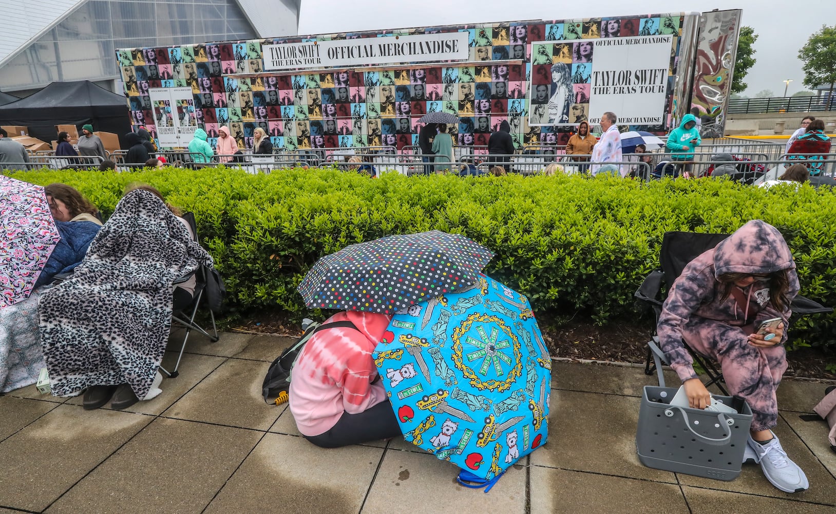 Taylor Swift fans braved cooler morning temperatures and drizzle while they waited in line before daybreak at the Georgia World Congress Center International Plaza outside Mercedes-Benz Stadium to buy official Swift merchandise on Thursday, April 27, 2023. (John Spink / John.Spink@ajc.com)