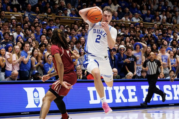 Duke's Cooper Flagg (2) drives past Florida State's Daquan Davis, left, during the second half of an NCAA college basketball game in Durham, N.C., Saturday, March 1, 2025. (AP Photo/Ben McKeown)