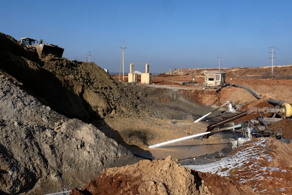 Miners extract ilmenite, a key element used to produce titanium, at an open pit mine in the central region of Kirovohrad, Ukraine, Wednesday, Feb. 12, 2025. (AP Photo/Efrem Lukatsky)