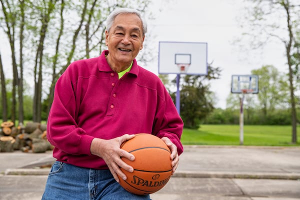 FILE - Leon Agullana, a member of the 1954 Muncie Central High School basketball team that lost to Milan High School in the Indiana state finals, poses at his home in Albany, Ind., Wednesday, May 20, 2020. The story of Milan's thrilling run to the Indiana state title inspired the movie "Hoosiers." (AP Photo/Michael Conroy, File)