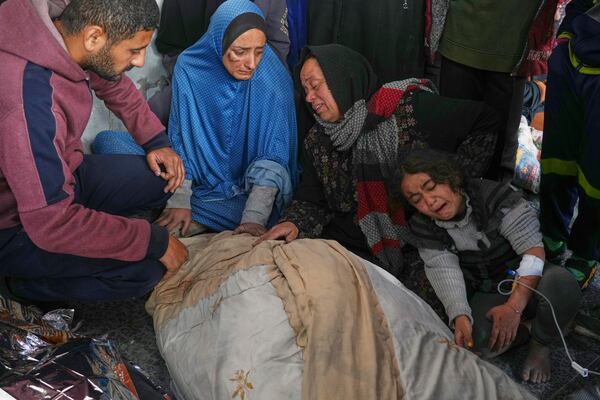 Members of the Al-Kahlout family mourn over the bodies of their relatives killed during an Israeli army strike before their burial at the Baptist hospital in Gaza City, Monday, March 24, 2025.(AP Photo/Jehad Alshrafi)