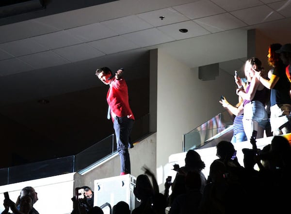 In a magic show-like move, Tyler Joseph disappears and then pops up high in the stands. Robb Cohen Photography /www.RobbsPhotos.com