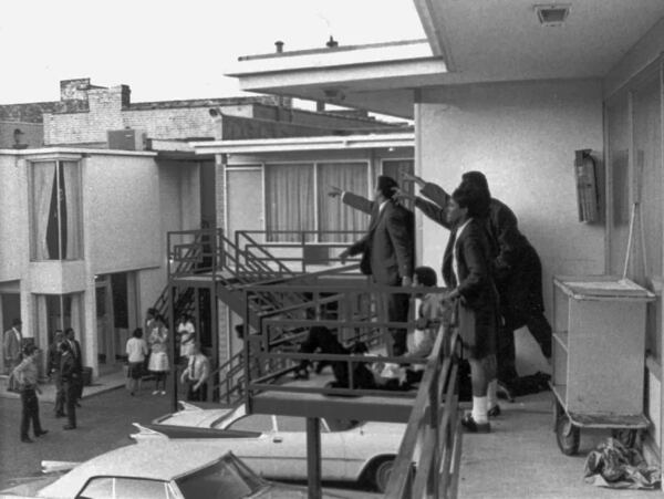 Caption: In a 1968 photo that was seen around the world, Young, center in the dark suit standing over the body of the Rev. Martin Luther King Jr., points with others in the direction from which the shot came that killed the civil rights leader at the Lorraine Motel in Memphis in 1968. (Joseph Louw / AP file)