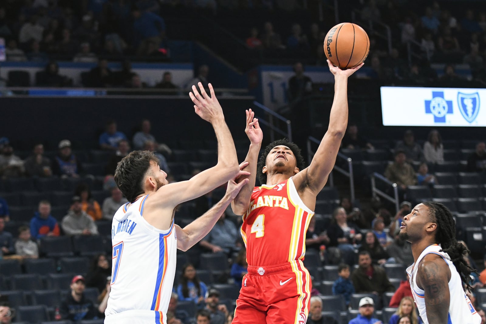 Atlanta Hawks guard Kobe Bufkin (4) shoots over Oklahoma City Thunder forward Chet Holmgren (7) during the first half of an NBA basketball game, Thursday, Oct. 17, 2024, in Oklahoma City. (AP Photo/Kyle Phillips)