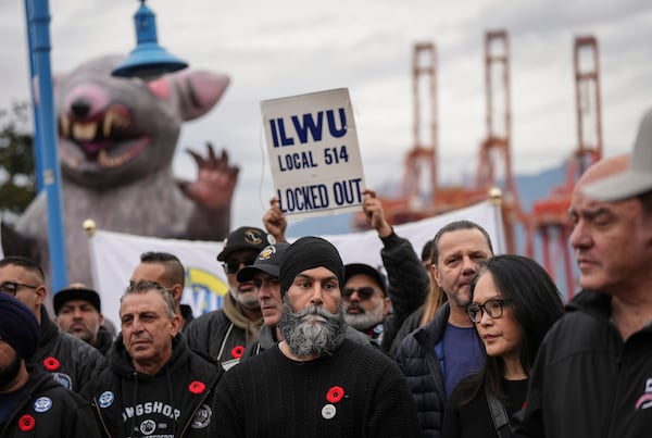 NDP Leader Jagmeet Singh, front center, and MP Jenny Kwan, front second right, attend a rally with locked out International Longshore and Warehouse Union Local 514 port workers and their supporters, in Vancouver, British Columbia, Friday, Nov. 8, 2024. (Darryl Dyck/The Canadian Press via AP)