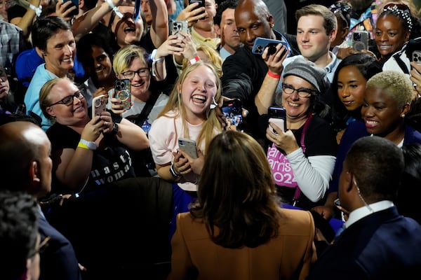 Democratic presidential nominee Vice President Kamala Harris, bottom center, greets supporters after speaking during a campaign rally Saturday, Oct. 26, 2024 at the Wings Event Center in Kalamazoo, Mich. (AP Photo/Jacquelyn Martin)