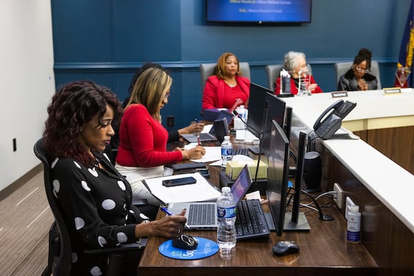 Sheena Robertson, left, deputy director of investigations for the Atlanta Citizen Review Board, listens during a board meeting in December at Atlanta City Hall. (Christina Matacotta for the AJC)